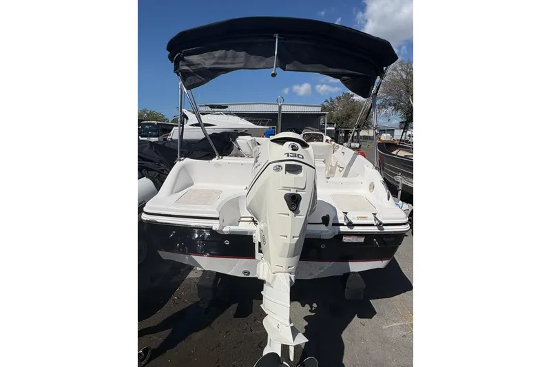 Slide: The Image of 2013 Hurricane SunDeck Sport 188 OB boat with outboard motor and canopy, parked outdoors. - 3