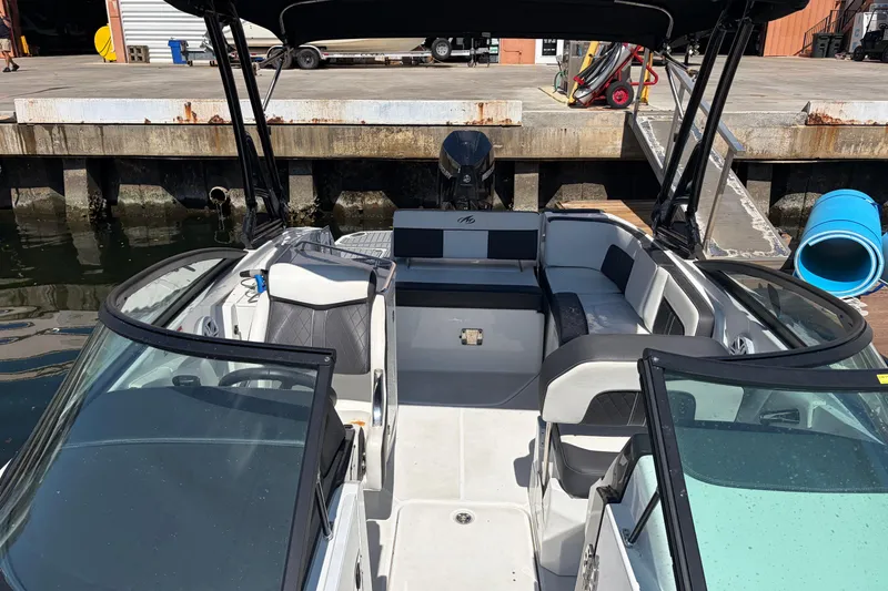 Slide: The Image of 2022 Monterey M-65 boat interior at dock, featuring spacious seating and modern design. - 10