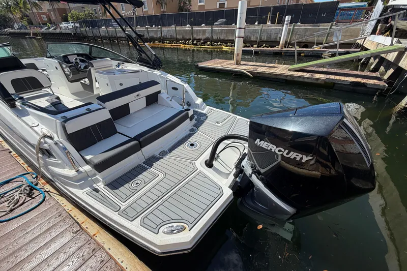 Slide: The Image of 2022 Monterey M-65 boat with Mercury engine docked on a sunny day. - 13