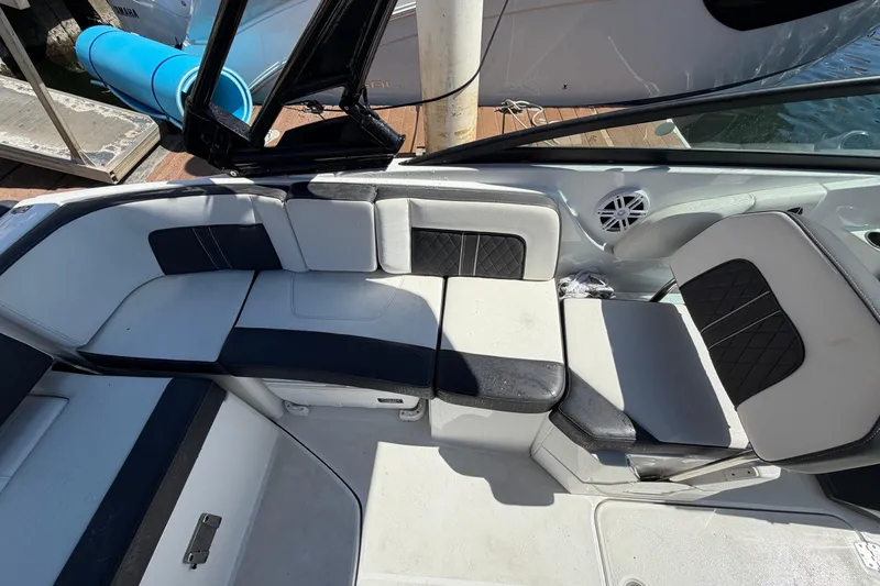 Slide: The Image of Interior seating of a 2022 Monterey M-65 boat, featuring black and white upholstery. - 9