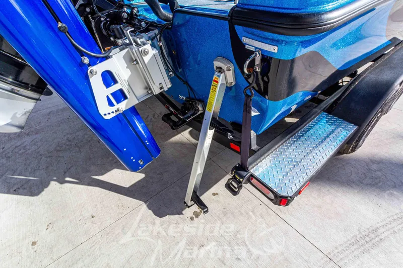 Slide: The Image of 2024 Recon 985 SC boat trailer with blue accents and stabilizing support. - 13