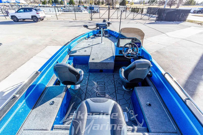 Slide: The Image of 2024 Recon 985 SC boat interior with blue accents and dual seating. - 15