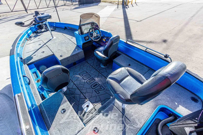 Slide: The Image of 2024 Recon 985 SC boat interior with blue accents and seating arrangement. - 16