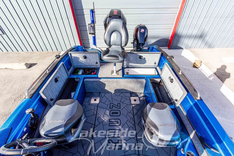 Slide: The Image of 2024 Recon 985 SC boat interior with storage compartments and seating. - 18
