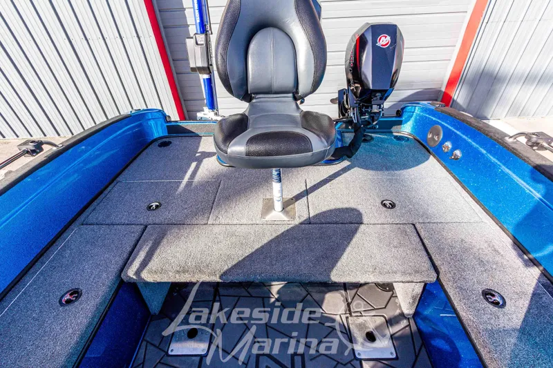 Slide: The Image of 2024 Recon 985 SC boat interior with seating and motor, at Lakeside Marina. - 19
