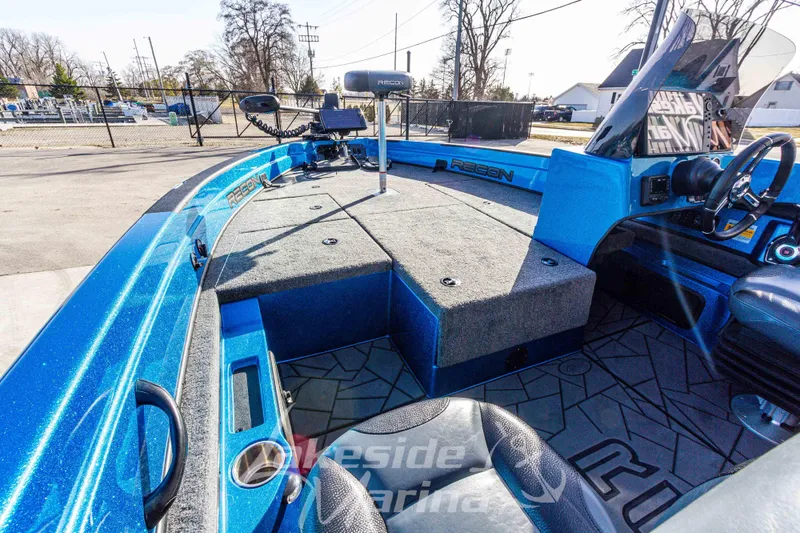 Slide: The Image of 2024 Recon 985 SC boat interior with blue finish and spacious seating. - 26