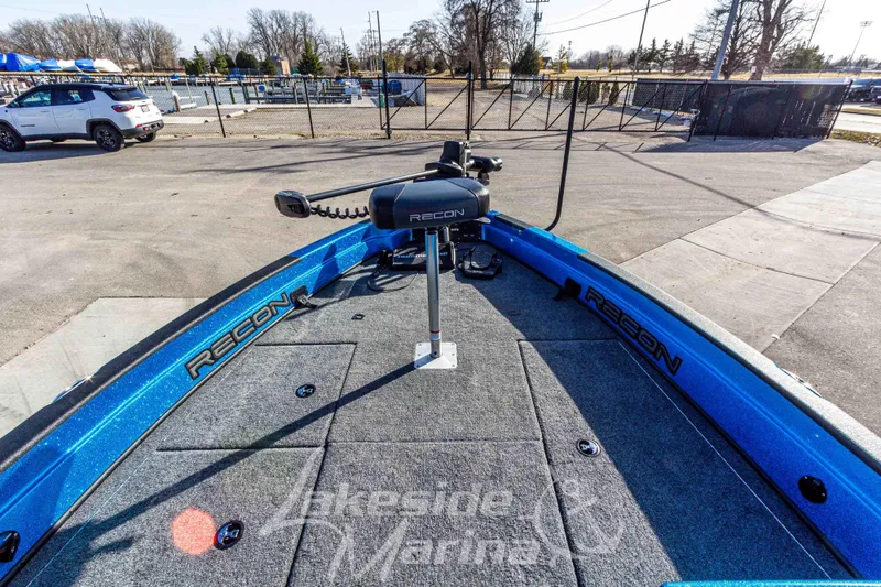 Slide: The Image of 2024 Recon 985 SC boat at Lakeside Marina, featuring a sleek blue design. - 30