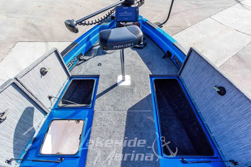 Slide: The Image of 2024 Recon 985 SC boat interior with storage compartments and seating. - 31