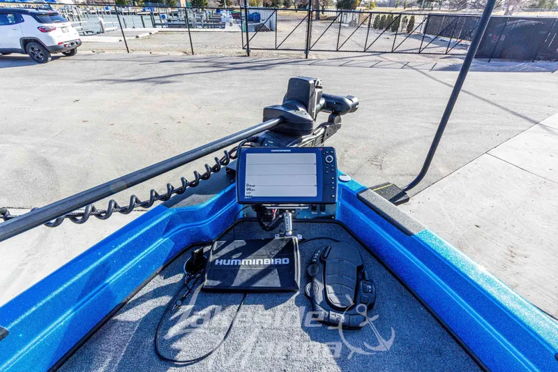 Slide: The Image of 2024 Recon 985 SC boat with Humminbird electronics and trolling motor, parked outdoors. - 32