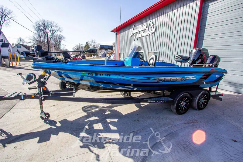 Slide: The Image of 2024 Recon 985 SC blue boat on trailer at Lakeside Marina. - 8