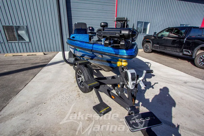 Slide: The Image of 2024 Recon 985 SC boat on trailer at Lakeside Marina, featuring a sleek blue design. - 9
