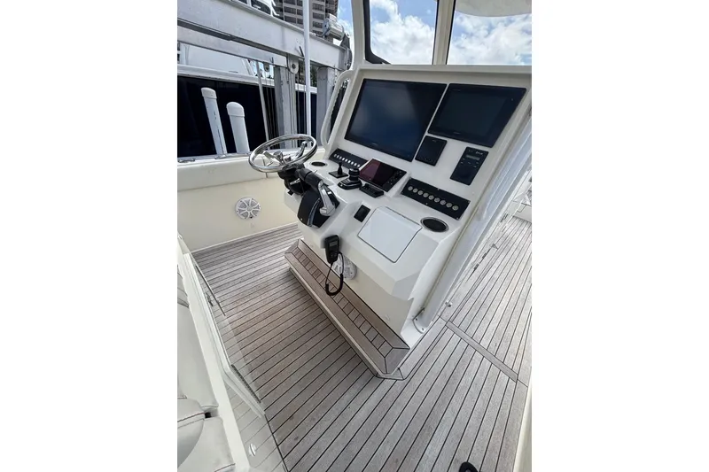 Slide: The Image of Control panel of 2018 Ocean 1 R boat with steering wheel and digital displays. - 12