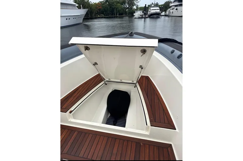 Slide: The Image of Open storage compartment on 2018 Ocean 1 R boat with wooden deck. - 14
