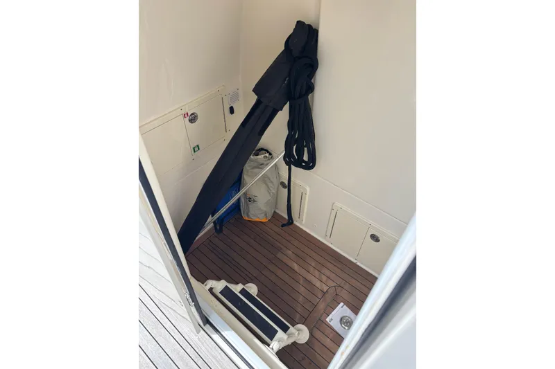 Slide: The Image of Interior of 2018 Ocean 1 R boat with wooden flooring and storage compartments. - 15