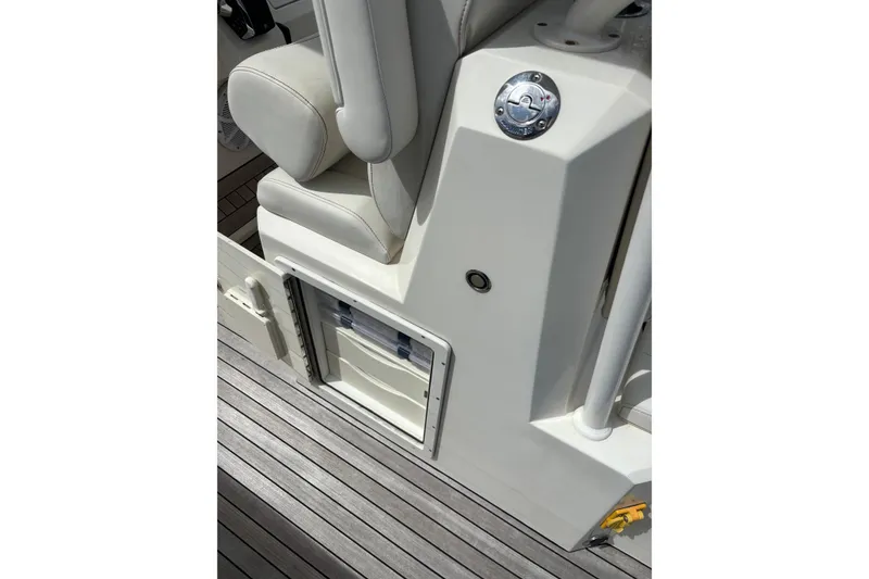 Slide: The Image of Interior of 2018 Ocean 1 R boat with white seating and storage compartment. - 16