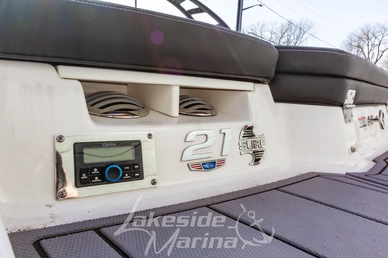 Slide: The Image of 2023 Chaparral 21 Surf boat interior with audio system and branding details. - 12