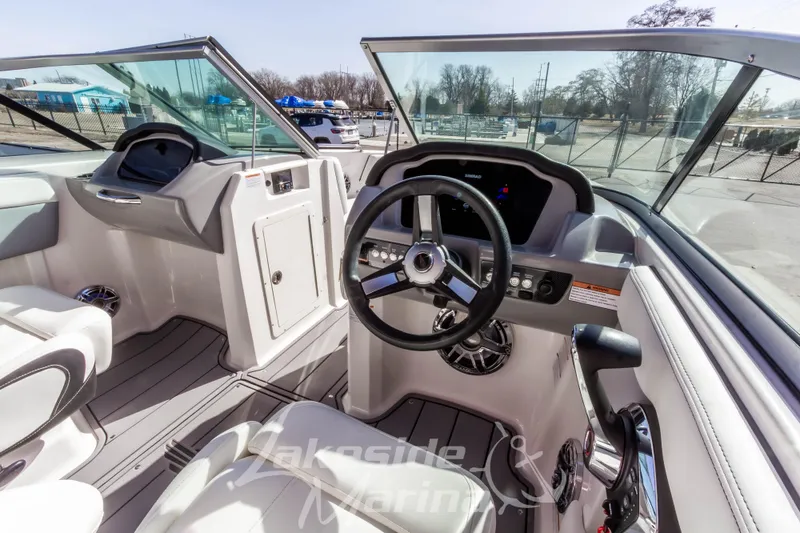 Slide: The Image of 2023 Chaparral 21 Surf boat interior with steering wheel and dashboard controls. - 24