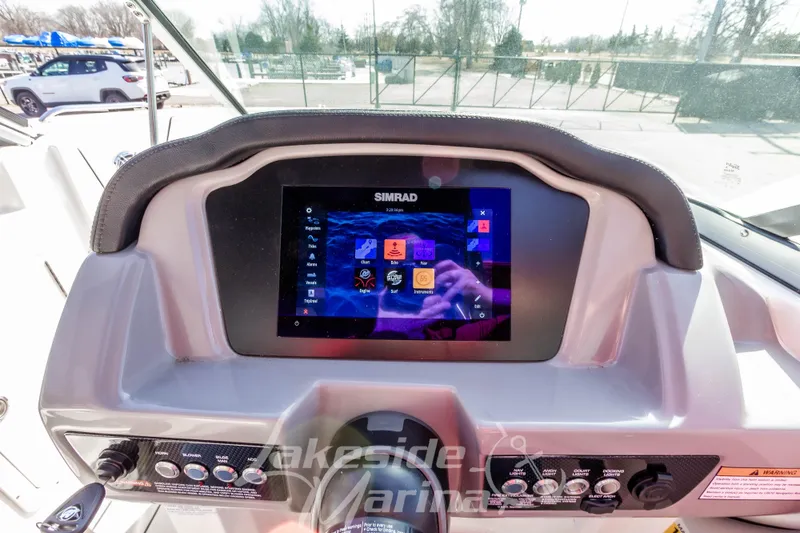 Slide: The Image of 2023 Chaparral 21 Surf dashboard with Simrad touchscreen display and control panel. - 26