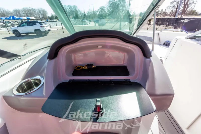 Slide: The Image of 2023 Chaparral 21 Surf boat dashboard with storage compartment and cup holder. - 29