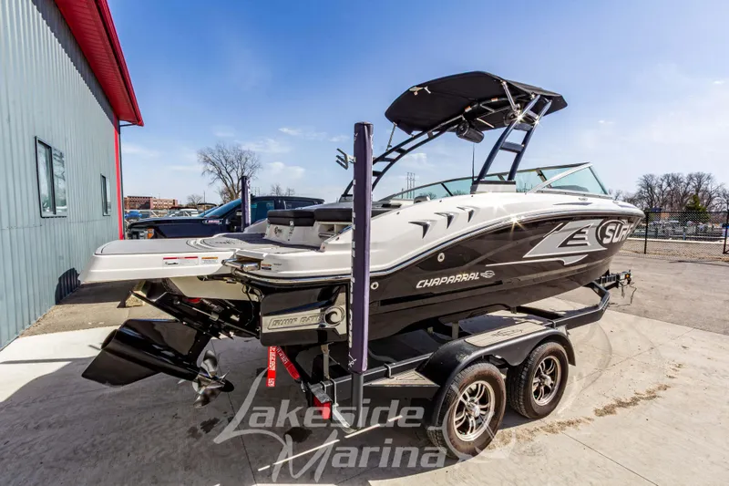 Slide: The Image of 2023 Chaparral 21 Surf boat on trailer at Lakeside Marina, sunny day. - 3