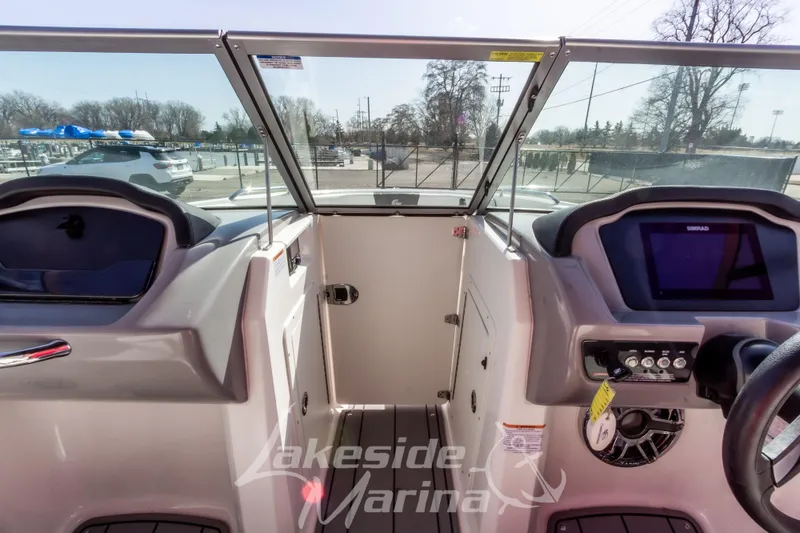 Slide: The Image of 2023 Chaparral 21 Surf boat interior with dashboard and controls at Lakeside Marina. - 30