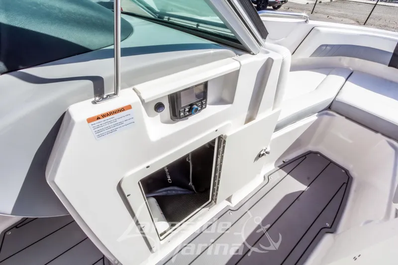 Slide: The Image of 2023 Chaparral 21 Surf boat interior with storage compartment and seating area. - 32