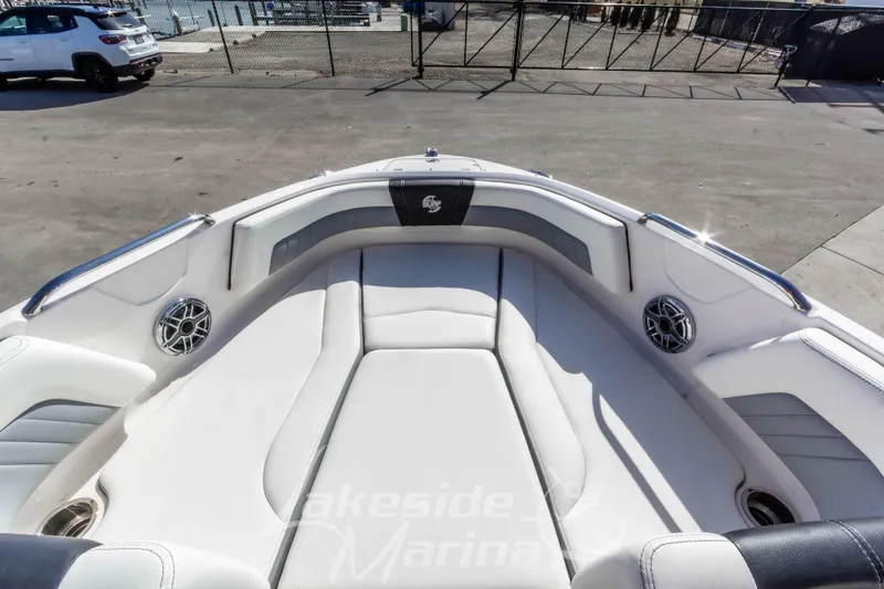 Slide: The Image of 2023 Chaparral 21 Surf boat interior with cushioned seating and speakers. - 33