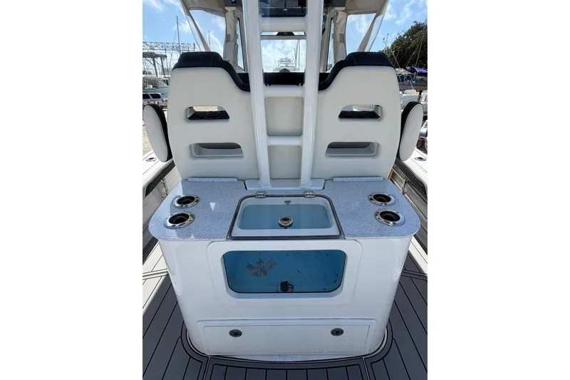 Slide: The Image of 2024 Tidewater 3100 Carolina Bay boat interior with seating and storage compartments. - 12