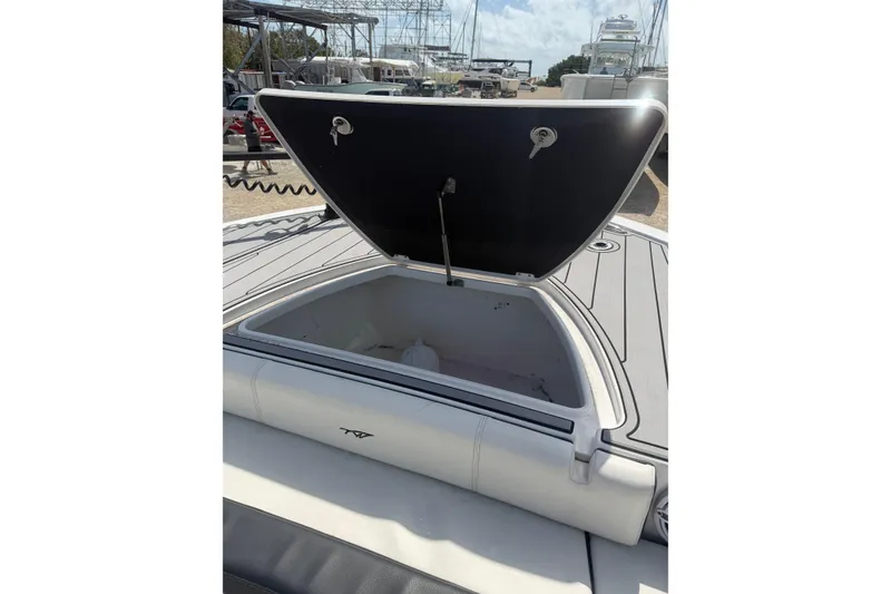 Slide: The Image of 2024 Tidewater 3100 Carolina Bay boat with open storage compartment on deck. - 29