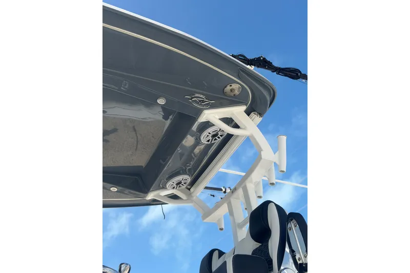 Slide: The Image of 2024 Tidewater 3100 Carolina Bay boat, featuring sleek design and modern equipment against a clear blue sky. - 33