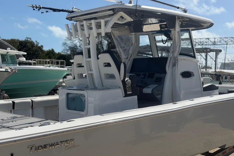 Slide: The Image of 2024 Tidewater 3100 Carolina Bay boat, sleek design, modern console, docked outdoors. - 4