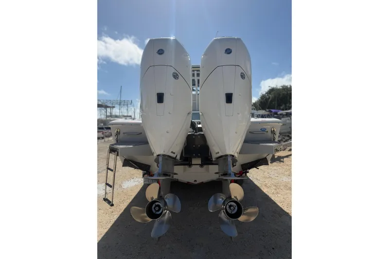Slide: The Image of 2024 Tidewater 3100 Carolina Bay boat with dual outboard engines, rear view. - 5