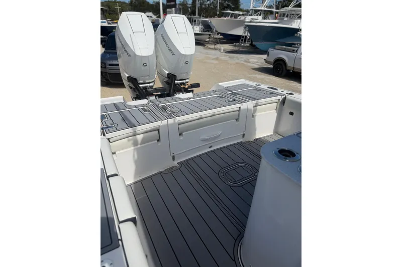 Slide: The Image of 2024 Tidewater 3100 Carolina Bay boat with dual Mercury engines, featuring sleek deck design. - 7