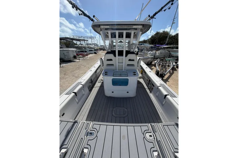 Slide: The Image of 2024 Tidewater 3100 Carolina Bay boat interior with spacious deck and seating. - 8