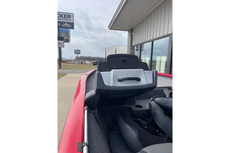 Slide: The Image of 2026 Tracker Pro Team 195 boat interior with console and seating, parked outside dealership. - 5