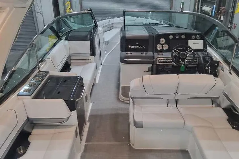 Slide: The Image of 2024 Formula 330 Crossover Bowrider I/O interior with luxurious seating and modern dashboard. - 12