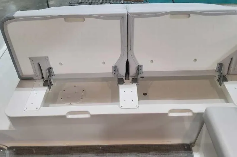 Slide: The Image of 2024 Formula 330 Crossover Bowrider I/O storage compartment with open lids. - 14