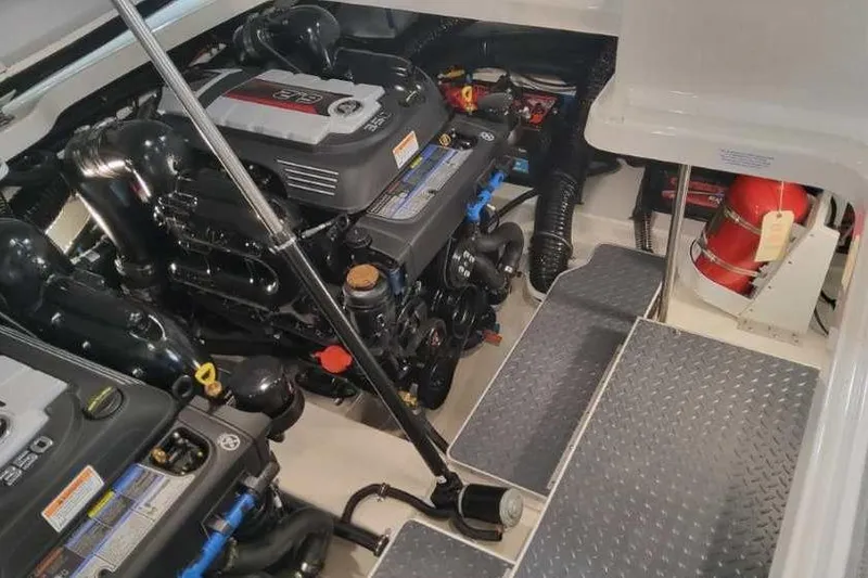 Slide: The Image of 2024 Formula 330 Crossover Bowrider I/O engine compartment with dual engines and fire extinguisher. - 17