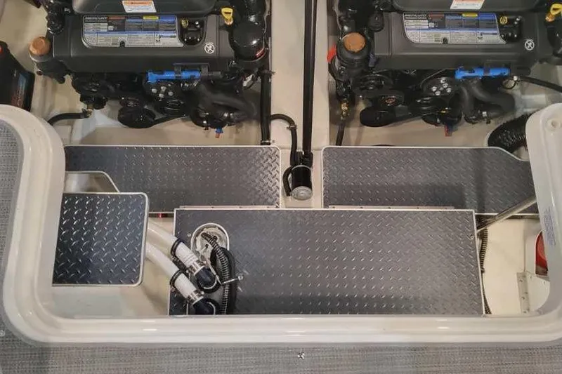 Slide: The Image of 2024 Formula 330 Crossover Bowrider I/O engine compartment with dual engines and diamond plate flooring. - 19
