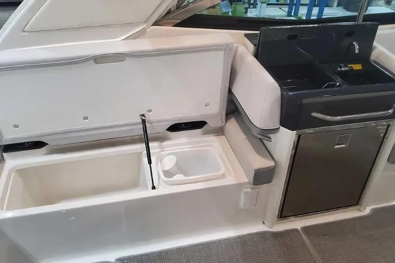 Slide: The Image of 2024 Formula 330 Crossover Bowrider I/O interior with storage and kitchenette features. - 20