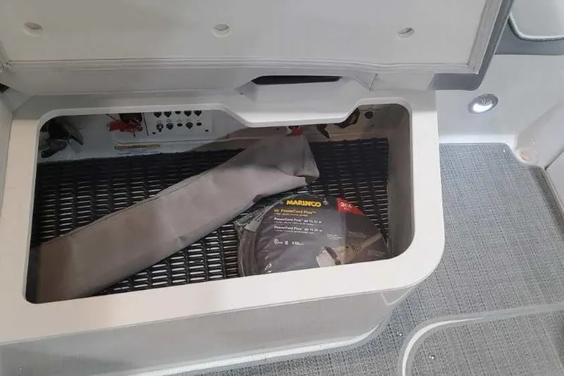 Slide: The Image of Storage compartment in 2024 Formula 330 Crossover Bowrider I/O with accessories and equipment. - 22