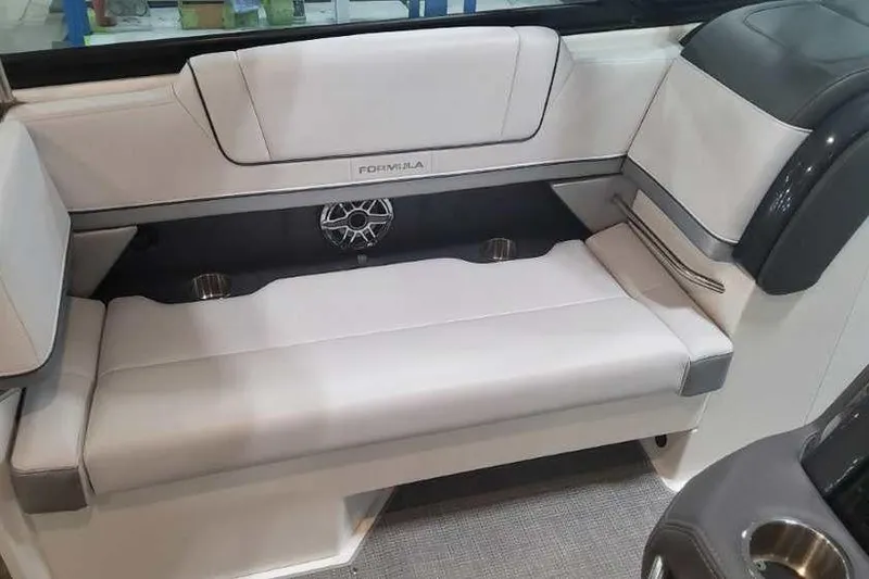 Slide: The Image of 2024 Formula 330 Crossover Bowrider I/O interior seating with speaker and cup holders. - 24