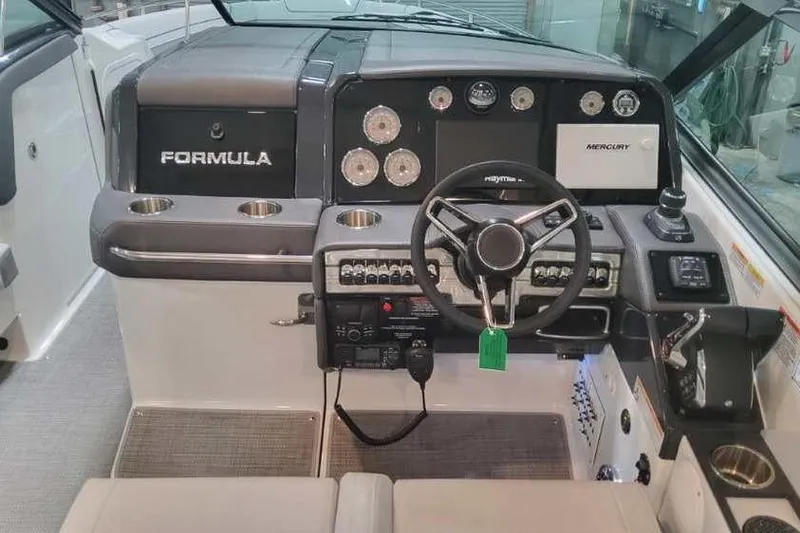 Slide: The Image of 2024 Formula 330 Crossover Bowrider I/O dashboard with steering wheel and control panel. - 27