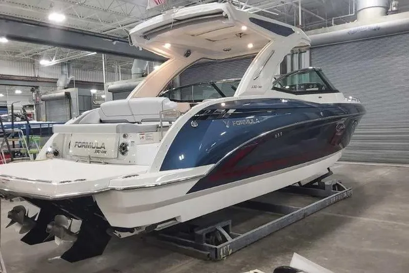 Slide: The Image of 2024 Formula 330 Crossover Bowrider I/O in a showroom, showcasing sleek design and luxury features. - 3