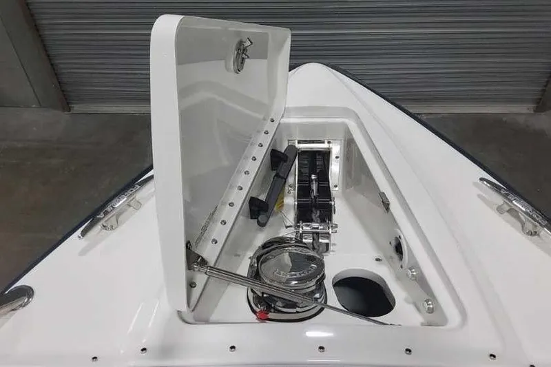 Slide: The Image of 2024 Formula 330 Crossover Bowrider I/O anchor compartment with open hatch, showcasing winch system. - 32