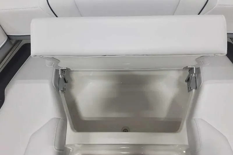 Slide: The Image of 2024 Formula 330 Crossover Bowrider I/O storage compartment with white cushioned seating. - 33