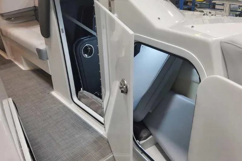 Slide: The Image of 2024 Formula 330 Crossover Bowrider I/O interior cabin with open door, showcasing seating area. - 38