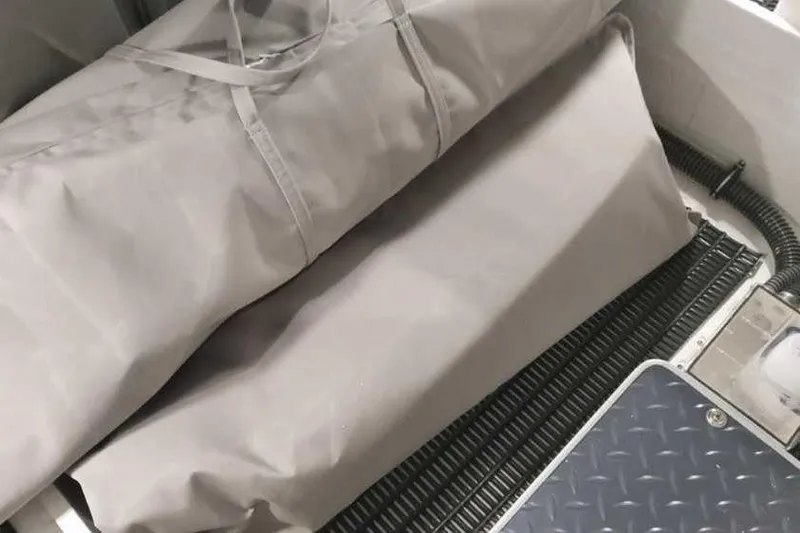 Slide: The Image of 2024 Formula 330 Crossover Bowrider I/O interior with protective covers and textured flooring. - 42