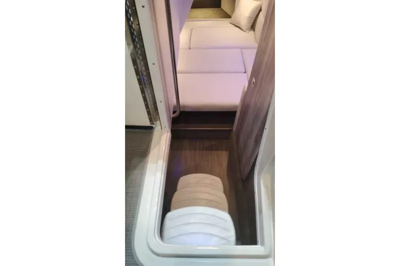 Slide: The Image of 2024 Formula 330 Crossover Bowrider I/O cabin interior with seating and cushions. - 44