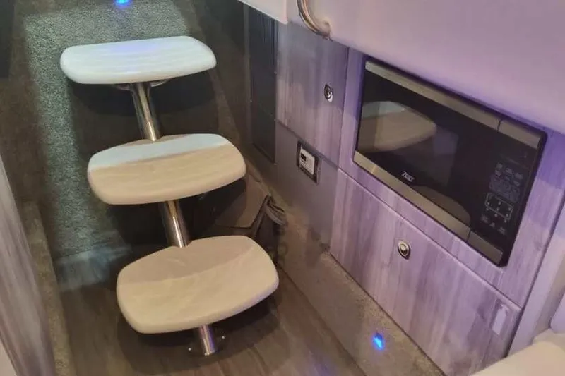 Slide: The Image of 2024 Formula 330 Crossover Bowrider I/O interior with modern steps and built-in microwave. - 45